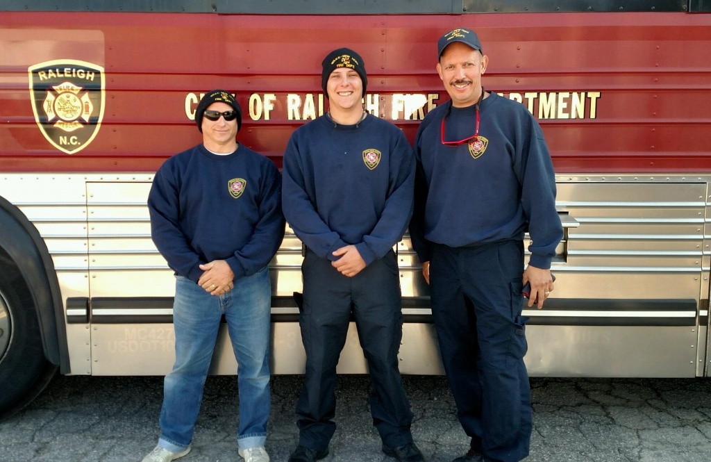 Captain Rigda, Firefighter Green, & Firefighter Martinez preparing to depart with the task force
